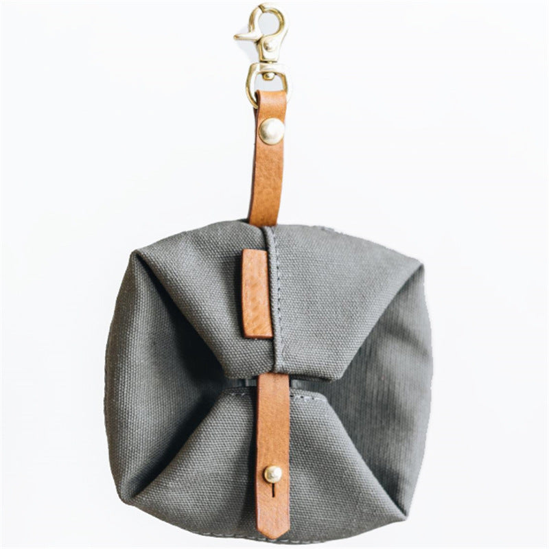 Compact foldable dog bowl next to hiking backpack for size reference