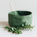 Foldable waterproof dog travel bowl in green, collapsed flat