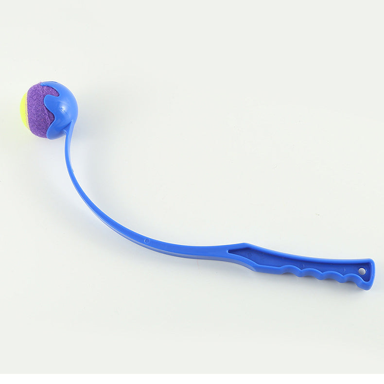 Dog fetch launcher toy in use at outdoor park throwing tennis ball