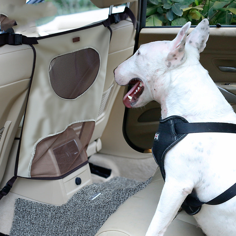 Dog behind car seat barrier safely separated from driver area